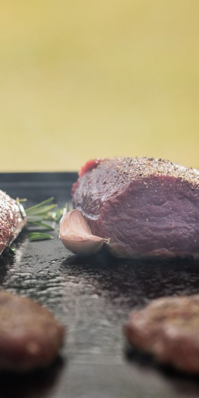 venison fillets and patties on the barbeque